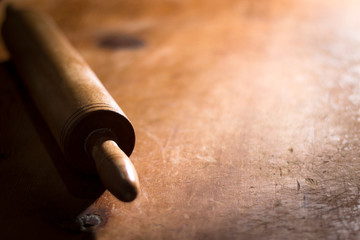 Rolling pin dough material on wooden background