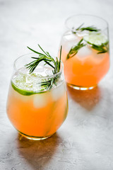 healthy morning with fresh drink, lime and rosemary on stone table background