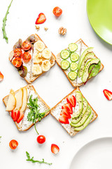 healthy breakfast with sandwiches set on white background top view