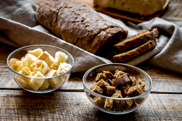 making crumbs from rye and wheat bread wooden background
