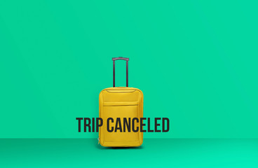 Yellow travel suitcase, Concept of Caneled trip to risk places COVID-19. crisis in tourism industry concept.