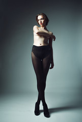 Obraz premium model with short blond hair wearing black pantyhose