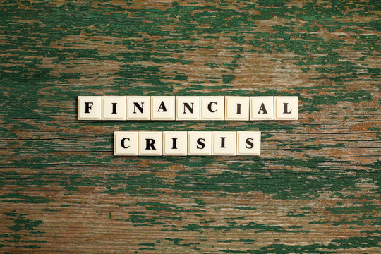 Phrase Financial Crisis Made Of Plastic Block Letters On Old Wooden Backgraund