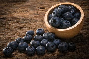 Blueberries in bowl on  on the wooden table, Fresh raw berries  on wood background.