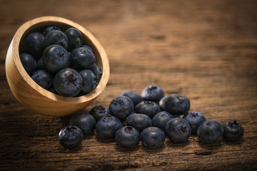 Blueberries in bowl on  on the wooden table, Fresh raw berries  on wood background.