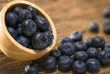 Blueberries in bowl on  on the wooden table, Fresh raw berries  on wood background.