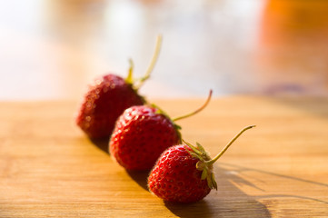 fresh ripe berries strawberries on bamboo board, close up