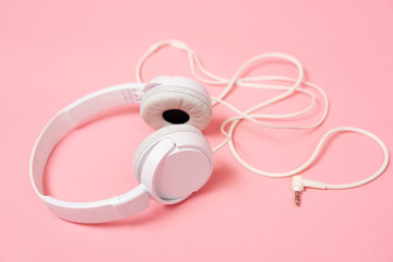 Music: White headphone on a pink background.