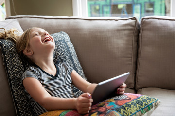 A young girl video chats with her classmates and friends during the Covid-19 pandemic social distancing.