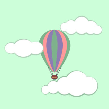 multi-colored balloon for flying on a light green background with clouds
