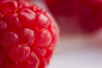 raspberries on a white saucer close up, macro photo