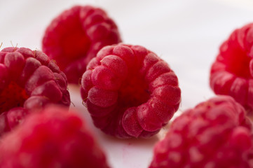 raspberries on a white saucer close up