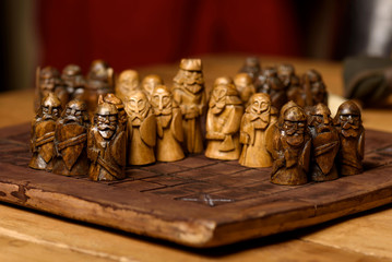 Wooden Viking chess hnefatafl on a wooden carved board made of dark wood, handmade