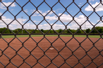 Baseball field through grid of chain link fence