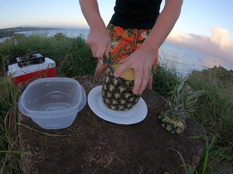 A Man Cutting His Pineapple  On The Cliff On Hawaii Island Recorded On The Go Pro Time Laps