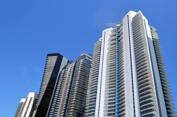 Fototapeta na wymiar Exteriors of ultra-modern luxury condominium towers soaring high above Collins Avenue in North Miami Beach,Florida