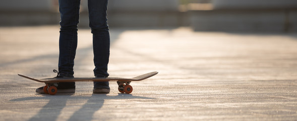 Skateboarder skateboarding at sunrise park