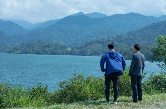 Two people talking near lake