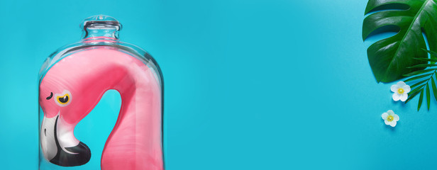 Quarantined summer, vacations canceled. Creative idea of isolation. Idea COVID-19 virus pandemic, protection 2019-ncov coronavirus infection. Sad flamingo isolated under cap. Copy space Minimalism