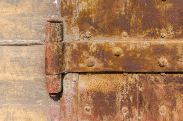 Old weathered rusty factory gate in the sunlight