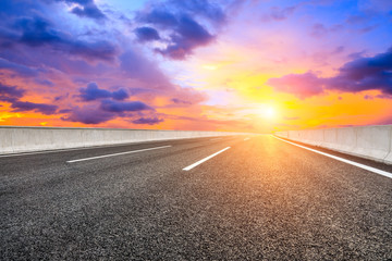Asphalt highway road and sky sunset clouds landscape.