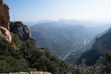 Beautiful Mountain panorama view. Lovely scenery landscape with blue sky, stones, trees, hills and valley. 