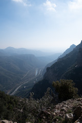 Obraz premium Beautiful Mountain panorama view. Lovely scenery landscape with blue sky, stones, trees, hills and valley. 