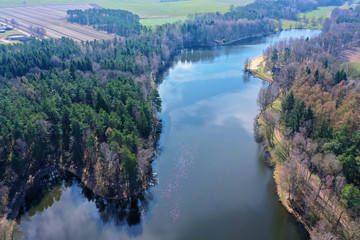 Aerial view of a Lake in the heath in northern Germany for recreational use, with dense forest along the banks