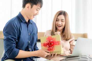 Man give a gift box to woman