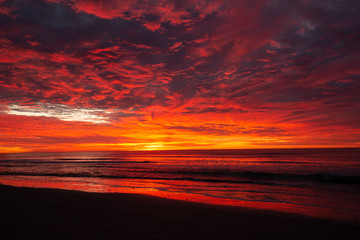 Fototapeta na wymiar orange fire sunset on beach