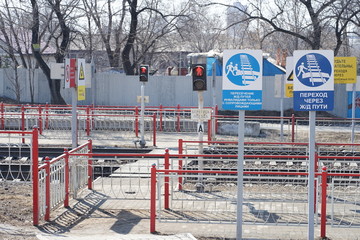 Equipped railway pedestrian crossing with signs and road signs