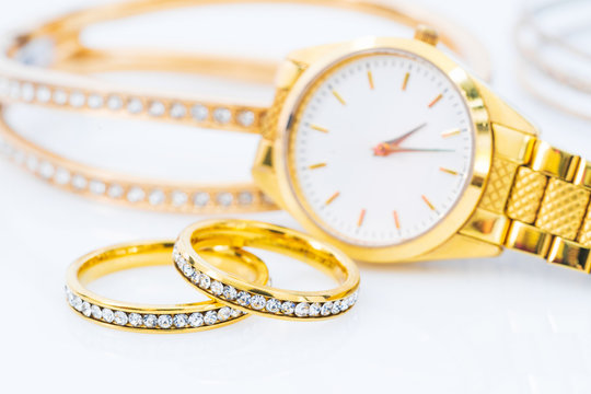 Luxury Gold Ring And Lady Gold Watch On White