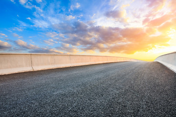 Asphalt highway road and sky sunset clouds landscape.