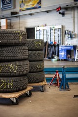 tires stacked stored in auto mechanics garage