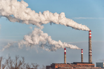 Factory smoke against a blue sky