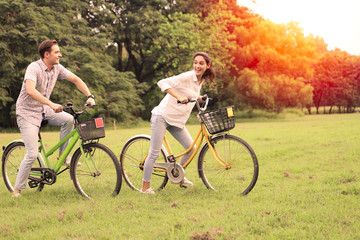 Fototapeta na wymiar Couple love resting or relaxing in a green park, hugging action and looking forward and ride on back for romantic date or vacation in valentine day