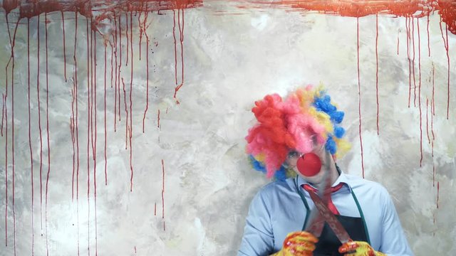 the man in the clown suit in the background of the bloody wall with a knife