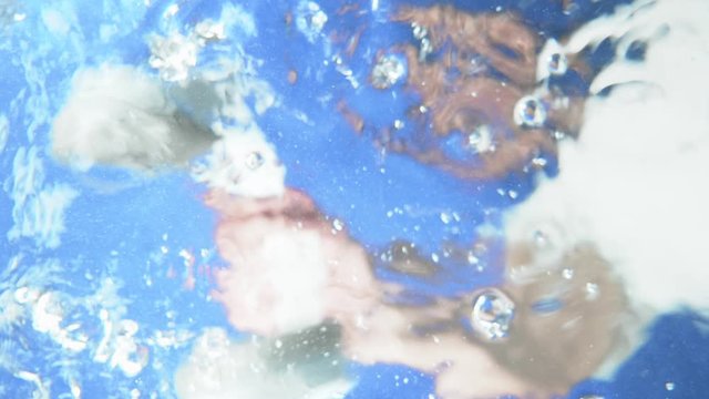 The man threw the headphones under the water and took them out. under water