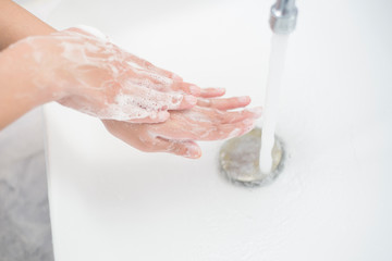 Fototapeta premium A woman is washing hands