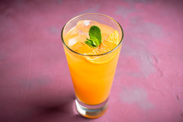 Fresh cocktail with vodka and orange juice on the rustic background. Selective focus. Shallow depth of field.