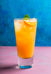 Fresh cocktail with vodka and orange juice on the rustic background. Selective focus. Shallow depth of field.