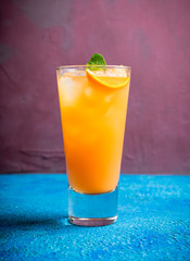 Fresh cocktail with vodka and orange juice on the rustic background. Selective focus. Shallow depth of field.