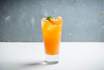 Fresh cocktail with vodka and orange juice on the rustic background. Selective focus. Shallow depth of field.