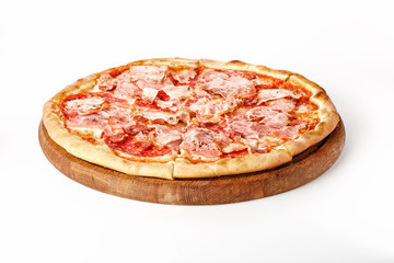 Pizza with meat, sausages and tomatoes on a wooden plate isolated on a white background.