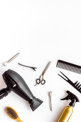 Professional hairdressing set with combs and hairdryer on white background top-down frame copy space