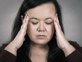 Worried woman having painfull headache