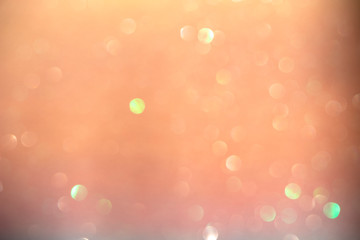 Soft focus, light bokeh on orange background.
