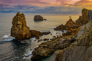 Incredible cliffs on the coast near the village of Liencres before sunrise. Cantabria. Northern coast of Spain