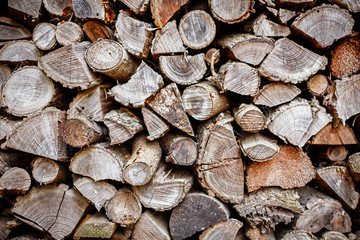 Fragment of stacked old firewood. background for design.