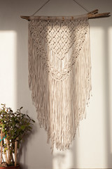 Wall panel in the style of Boho made of cotton threads in natural color using the macrame technique for home decor and wedding decoration. Beautiful boho macrame wall panel will add a cozy atmosphere © Мария Чичина